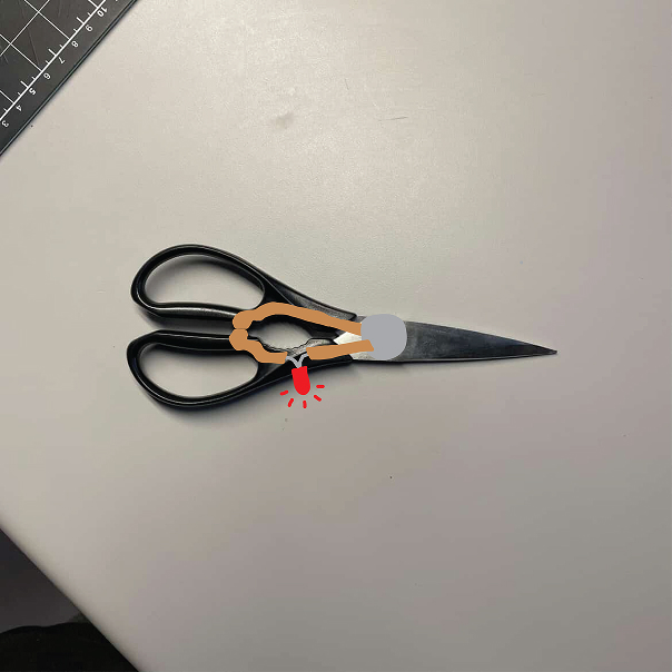 A circuit that shows a non-wearable circuit that closes when the scissors are closed, causing the LED's to activate.